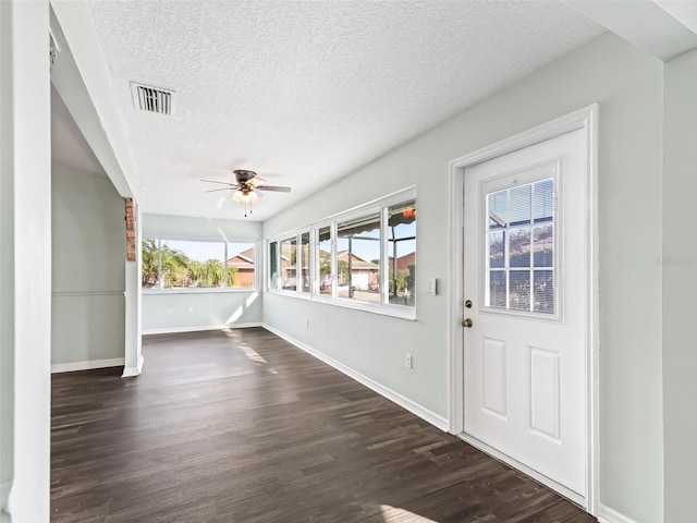 foyer entrance with dark hardwood / wood-style floors, ceiling fan, and a textured ceiling