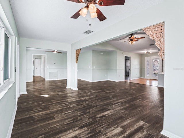 unfurnished living room with ceiling fan and dark hardwood / wood-style flooring