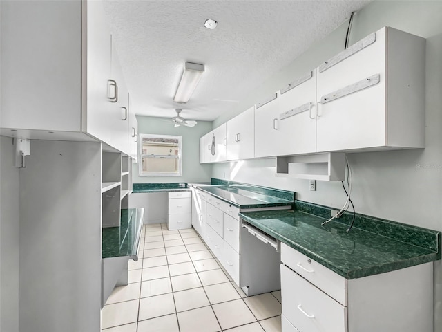 kitchen featuring dishwasher, ceiling fan, white cabinetry, and a textured ceiling