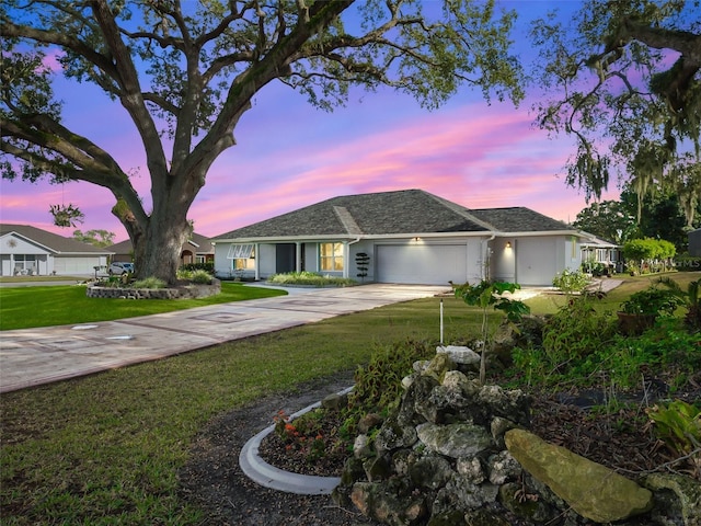 single story home featuring a yard and a garage