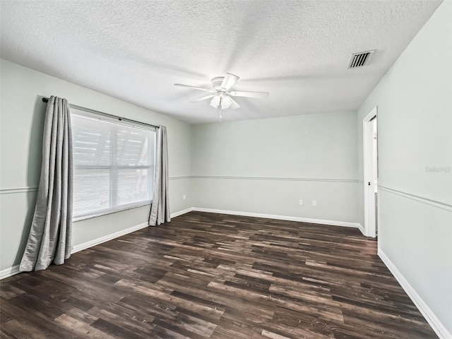 unfurnished room with baseboards, a textured ceiling, a ceiling fan, visible vents, and wood finished floors