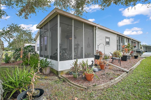 view of home's exterior with a sunroom