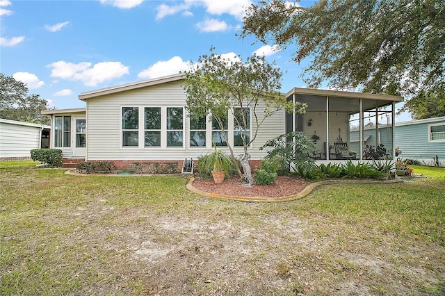 back of house featuring a sunroom and a yard