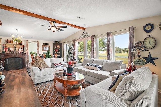 living room featuring a textured ceiling, dark hardwood / wood-style flooring, lofted ceiling with beams, and ceiling fan with notable chandelier