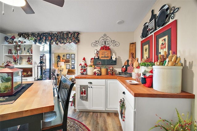 kitchen with wooden counters, white cabinets, ceiling fan, and light hardwood / wood-style floors