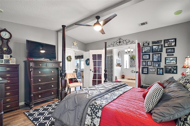 bedroom with a textured ceiling, dark wood-type flooring, ceiling fan, and lofted ceiling