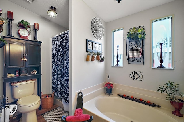 bathroom with wood-type flooring, toilet, and a bathtub