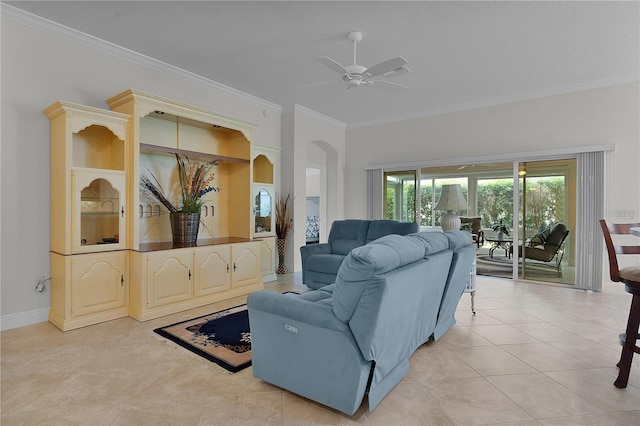 living room featuring ceiling fan, light tile patterned flooring, a textured ceiling, and ornamental molding