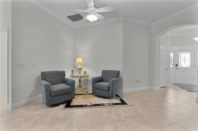 living area with ceiling fan, crown molding, and light tile patterned flooring