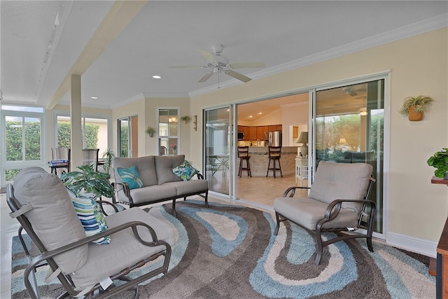 sunroom featuring ceiling fan