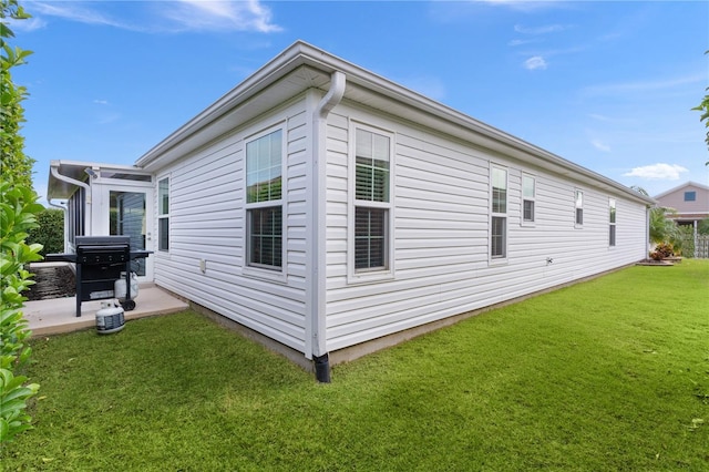 view of property exterior with a lawn and central air condition unit