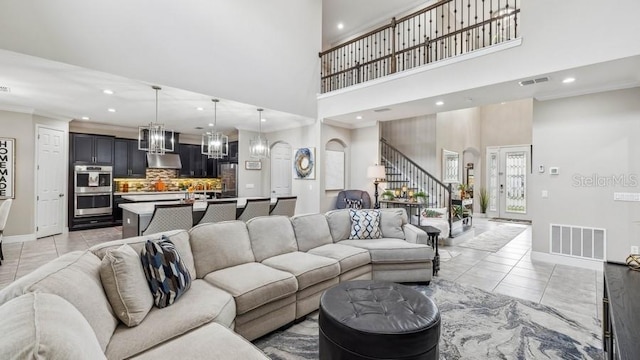 living room with a high ceiling and light tile patterned floors