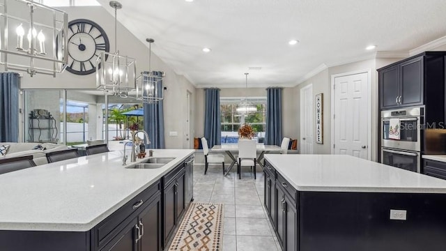 kitchen featuring a center island with sink, pendant lighting, sink, and stainless steel appliances