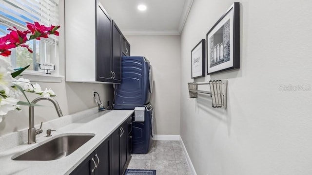 clothes washing area featuring cabinets, crown molding, sink, light tile patterned floors, and stacked washer / dryer