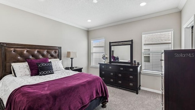 bedroom featuring light colored carpet, a textured ceiling, and ornamental molding