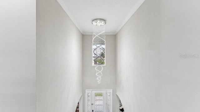 interior space with a chandelier and ornamental molding