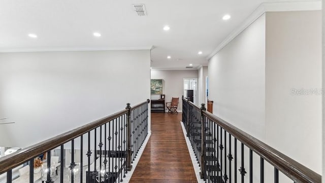 corridor with dark hardwood / wood-style flooring and ornamental molding