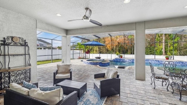 view of patio / terrace with pool water feature, an outdoor hangout area, glass enclosure, and ceiling fan