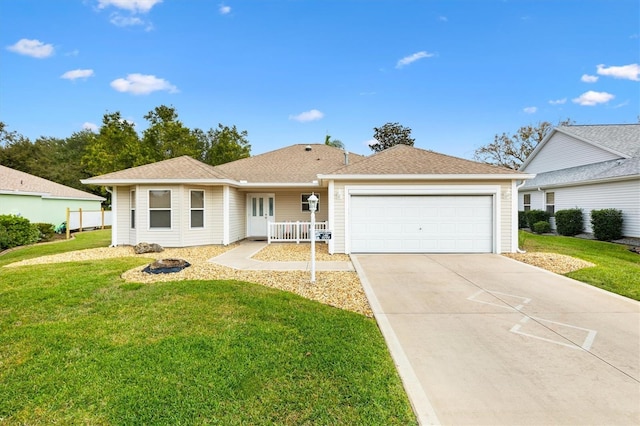 ranch-style house featuring covered porch, a front yard, and a garage