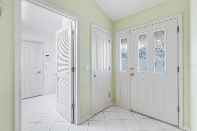 tiled foyer with vaulted ceiling