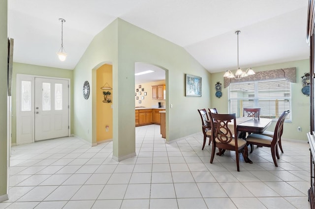 tiled dining area featuring a wealth of natural light, a chandelier, and vaulted ceiling