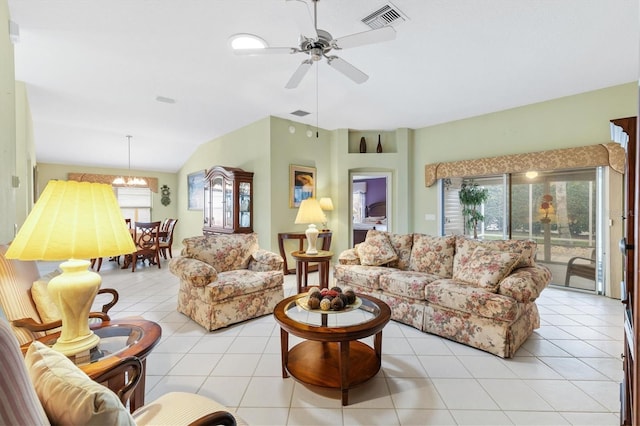 tiled living room with ceiling fan with notable chandelier and lofted ceiling