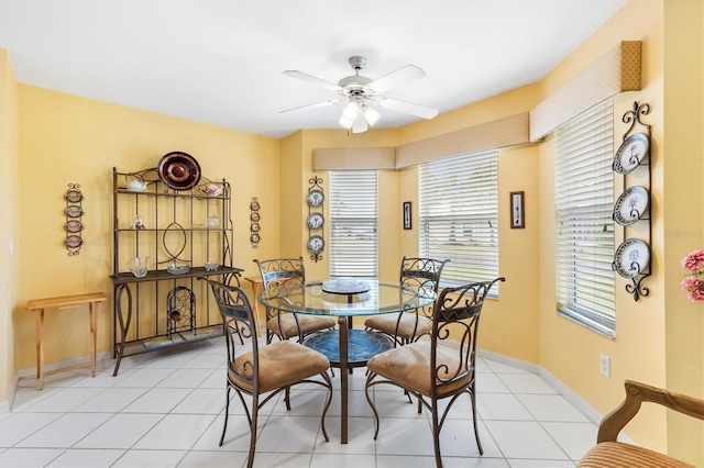 dining space with ceiling fan, a healthy amount of sunlight, and light tile patterned flooring