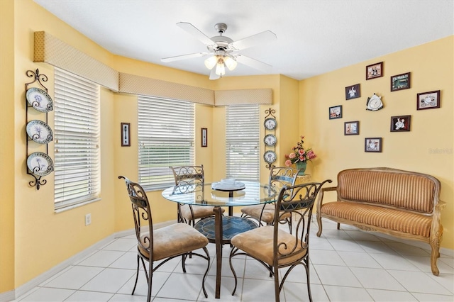 dining space featuring ceiling fan and light tile patterned floors