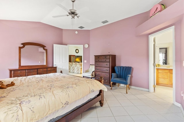 tiled bedroom with vaulted ceiling, ensuite bath, and ceiling fan