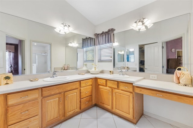 9199 SE 171st Cooper Loop, The Villages, FL 32162 - ensuite bathroom with vaulted ceiling, double vanity, a stall shower, and tile patterned floors