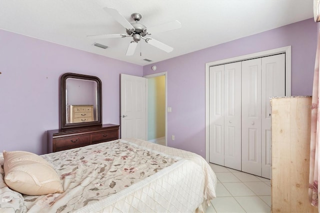 bedroom with ceiling fan, a closet, and light tile patterned floors