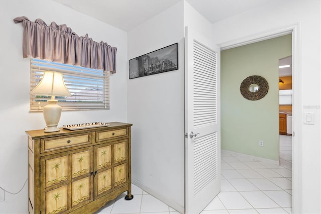 hall featuring light tile patterned floors