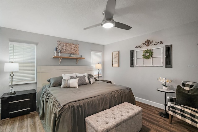 bedroom with a textured ceiling, dark hardwood / wood-style floors, and ceiling fan