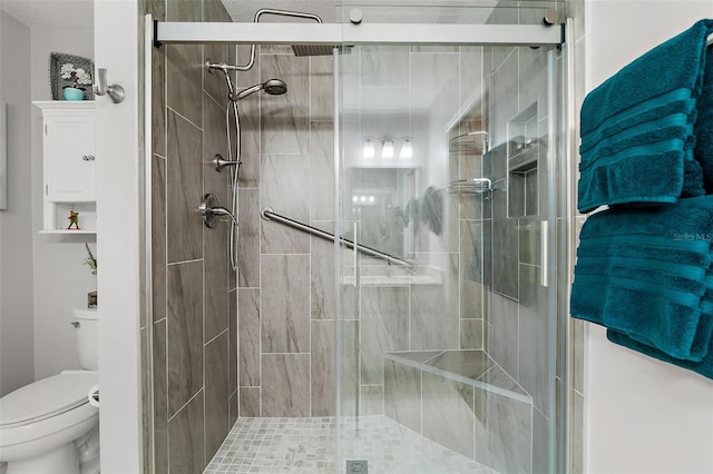 bathroom with an enclosed shower and toilet