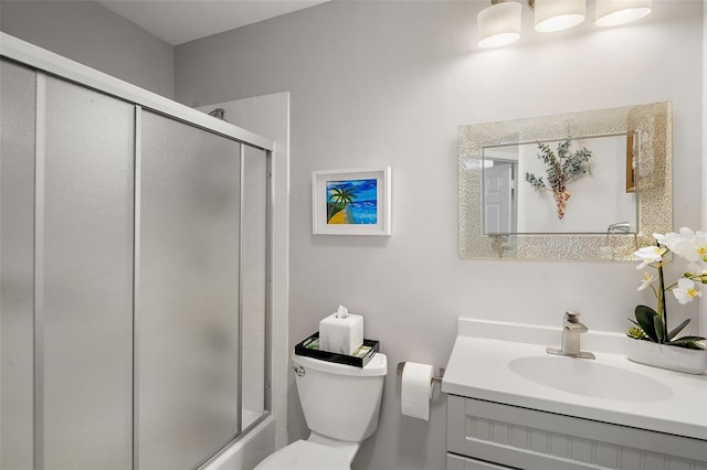 full bathroom featuring vanity, toilet, and shower / bath combination with glass door