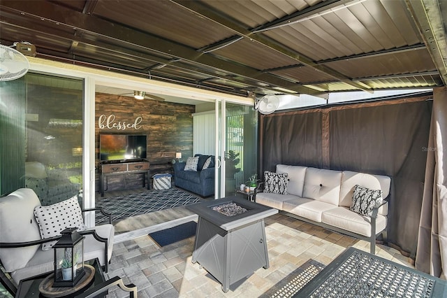 view of patio with an outdoor living space with a fire pit