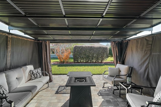 view of patio / terrace with an outdoor living space with a fire pit