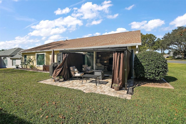 back of property with a lawn and a patio area