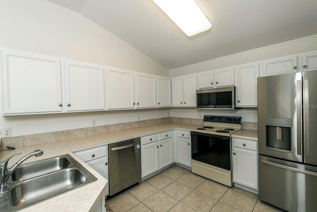 kitchen featuring white cabinets, sink, stainless steel appliances, and vaulted ceiling