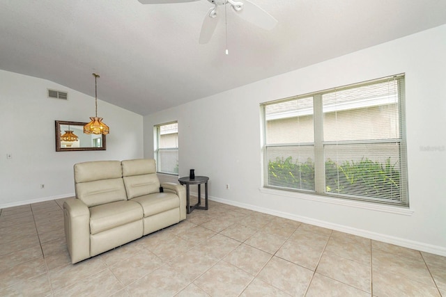 living room with light tile patterned floors, ceiling fan, and lofted ceiling