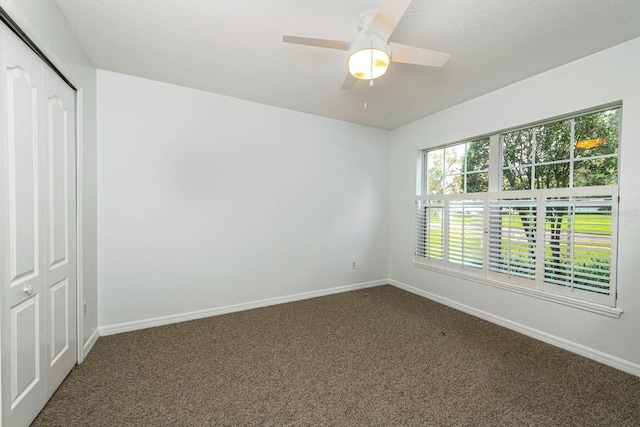 unfurnished bedroom with carpet flooring, ceiling fan, and a closet