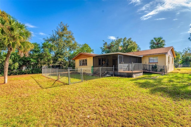 back of property featuring a sunroom and a lawn