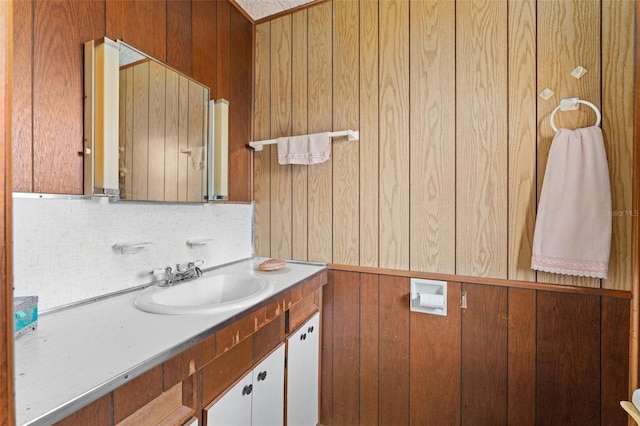 bathroom featuring vanity and backsplash