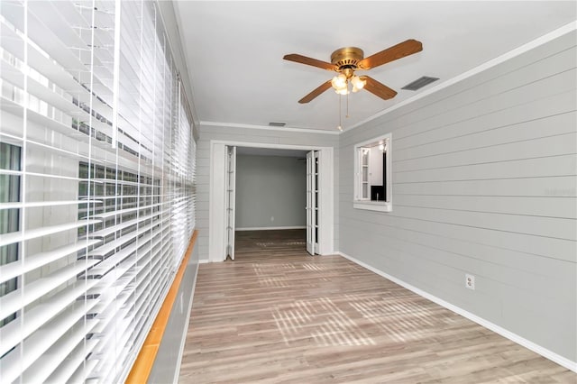 hall with ornamental molding and hardwood / wood-style flooring