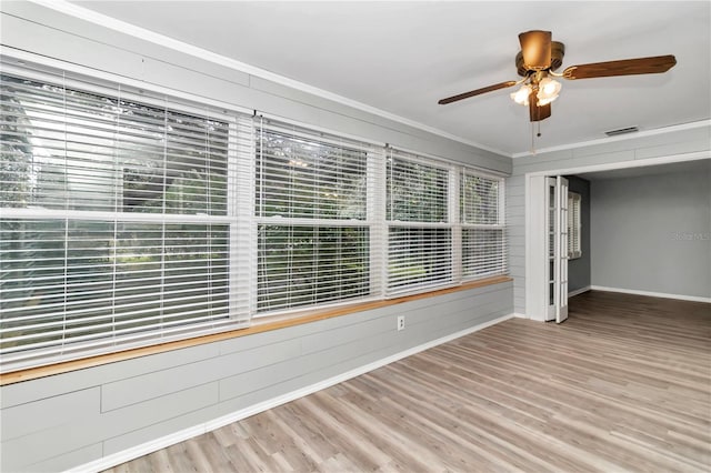 spare room with ceiling fan, wood-type flooring, and ornamental molding