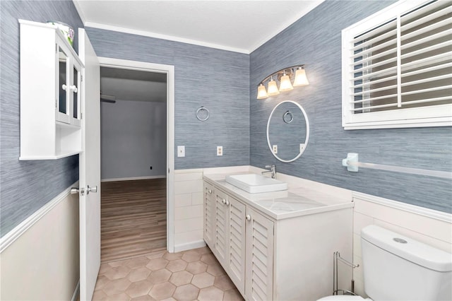 bathroom featuring tile patterned floors, toilet, vanity, and ornamental molding