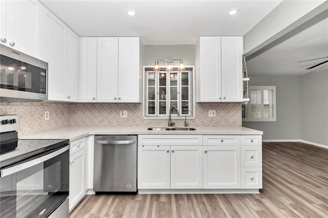 kitchen with sink, white cabinets, and stainless steel appliances