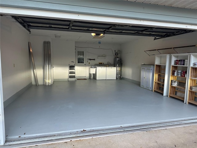 garage with separate washer and dryer, strapped water heater, and a garage door opener