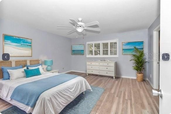 bedroom with light wood-type flooring and ceiling fan