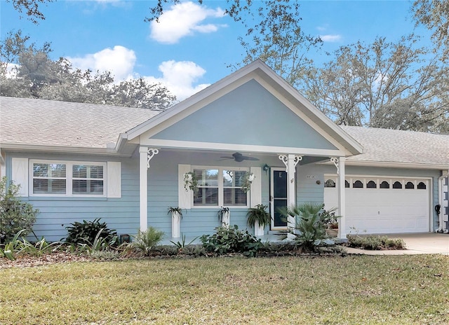 view of front facade with a garage, a front lawn, and ceiling fan